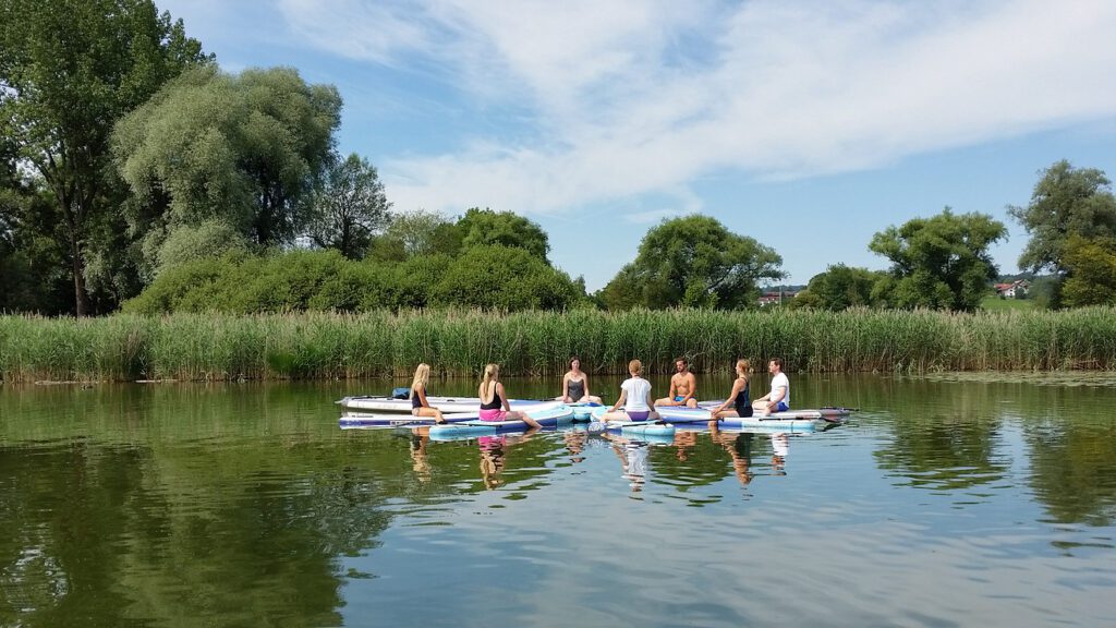 a group of people on paddle boards on a lake