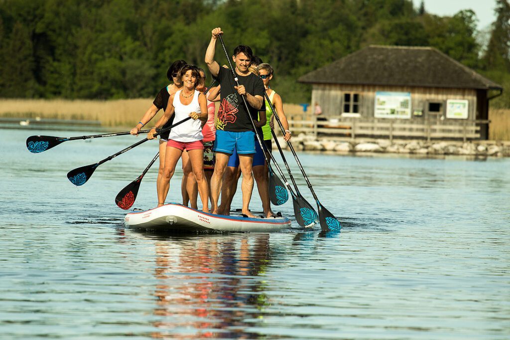 a group of people on paddle boards on a lake