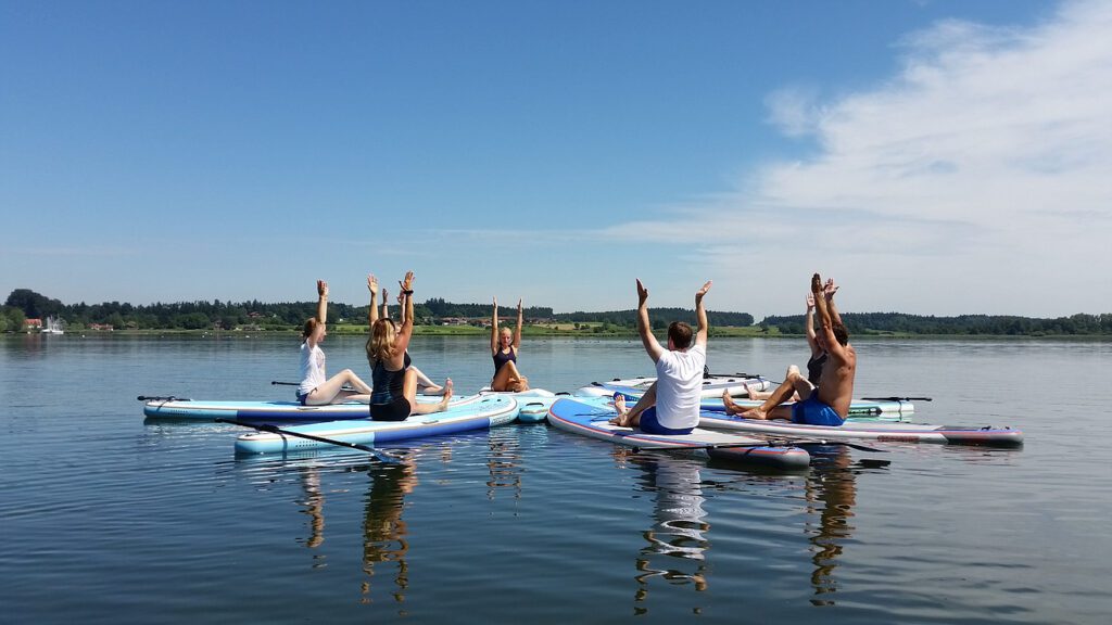 a group of people on paddle boards on a lake